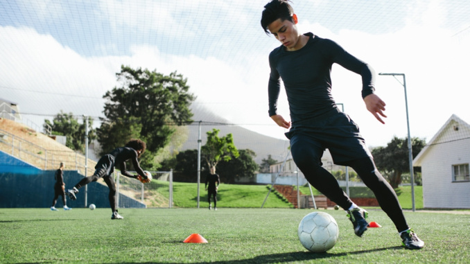 Football,Player,Training,In,Soccer,Field.,Young,Soccer,Player,Practicing